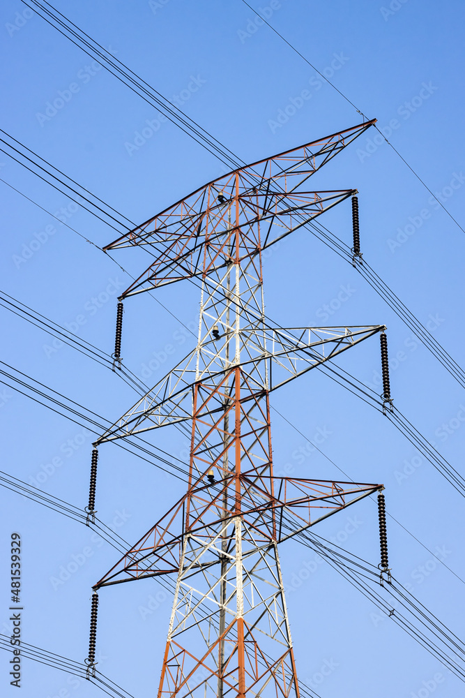 Power transmission tower close up shot under the blue sky Power transmission tower close up shot under the blue sky