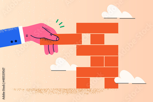 Businessman play jenga game risk in business project 