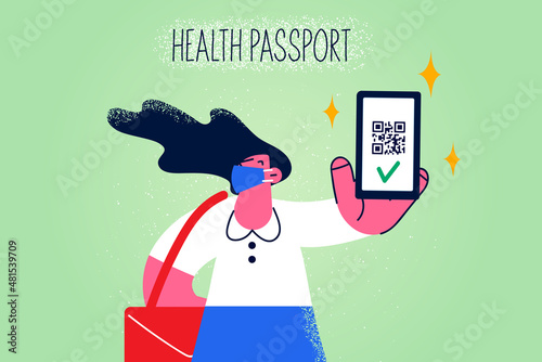 Woman in facemask show vaccination passport on mobile 