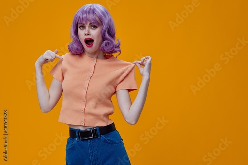 pretty woman purple hair fashion posing glamor yellow background unaltered