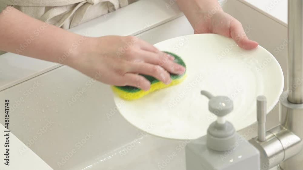 Woman housewife is doing the dishes at home kitchen. Woman housewife is doing the dishes at home kitchen.