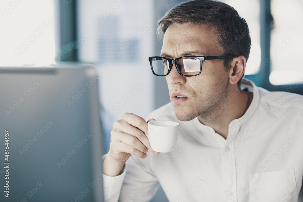 Worried businessman staring at the computer screen Worried businessman staring at the computer screen
