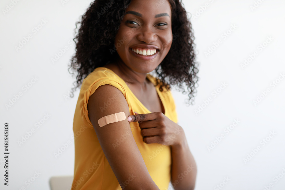 Vaccinated African Woman Showing Arm After Vaccination Over Gray Background Vaccinated African Woman Showing Arm After Vaccination Over Gray Background