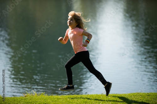 Kids jogging in park outdoor. Little boy running in nature. Active healthy child boy runner jogging outdoor. Active energetic childhood.