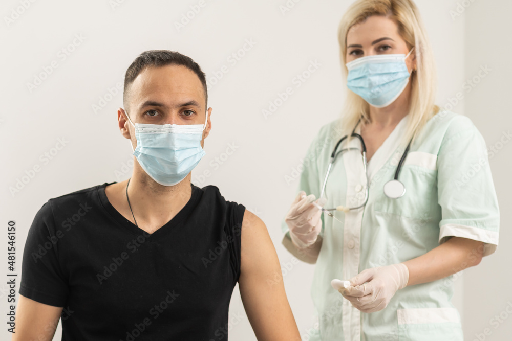 doctor make injection Covid-19 or coronavirus vaccine to patient in medical mask doctor make injection Covid-19 or coronavirus vaccine to patient in medical mask