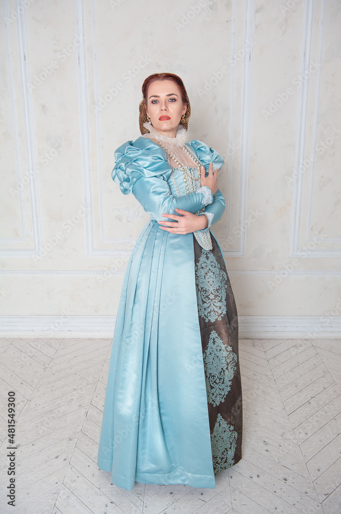Beautiful young woman in medieval style blue dress