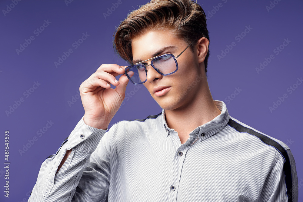 Handsome young guy in stylish eyewear while looking away. Stylish hairstyle. Fashion man Handsome young guy in stylish eyewear while looking away. Stylish hairstyle. Fashion man