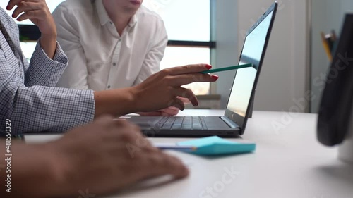 Close-up cropped shot of businessman showing computer presentation to client, sharing new business strategy with colleagues pointing on laptop screen. Business communication concept, slow motion.