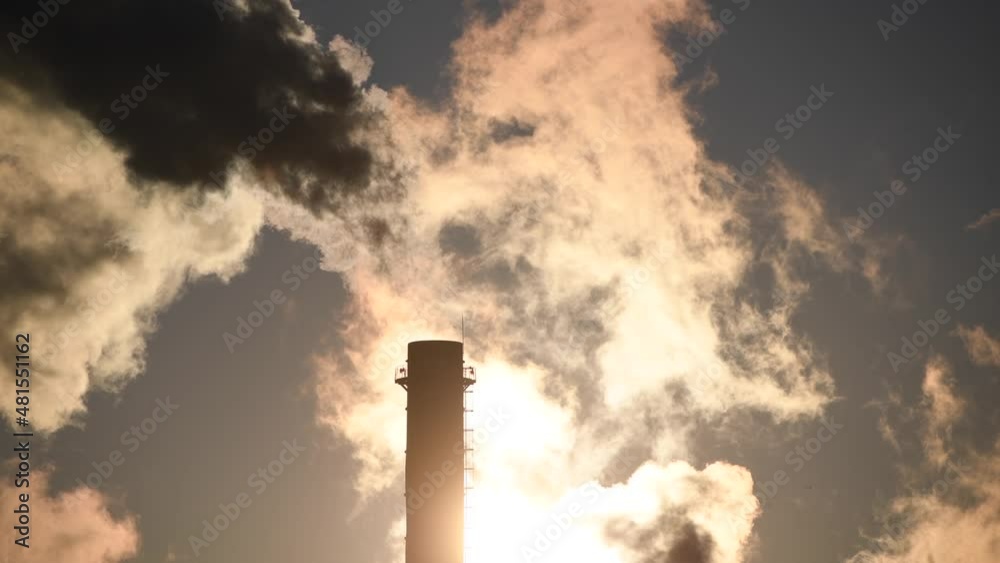 Smoke is getting out of cooling chimney of a thermal power plant. Pollution inside a city, danger for the environment. 4k video Smoke is getting out of cooling chimney of a thermal power plant. Pollution inside a city, danger for the environment. 4k video