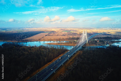 Large modern bridge over river in europe city with car traffic, aerial view. Redzinski bridge over Oder in Wroclaw, Poland photo