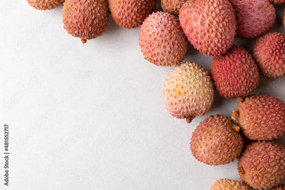 Fresh lychee fruit on grey background. Copy space Fresh lychee fruit on grey background. Copy space