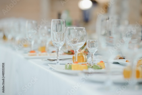beautifully laid tables with glasses and appliances at morning in restaurant © Serhii