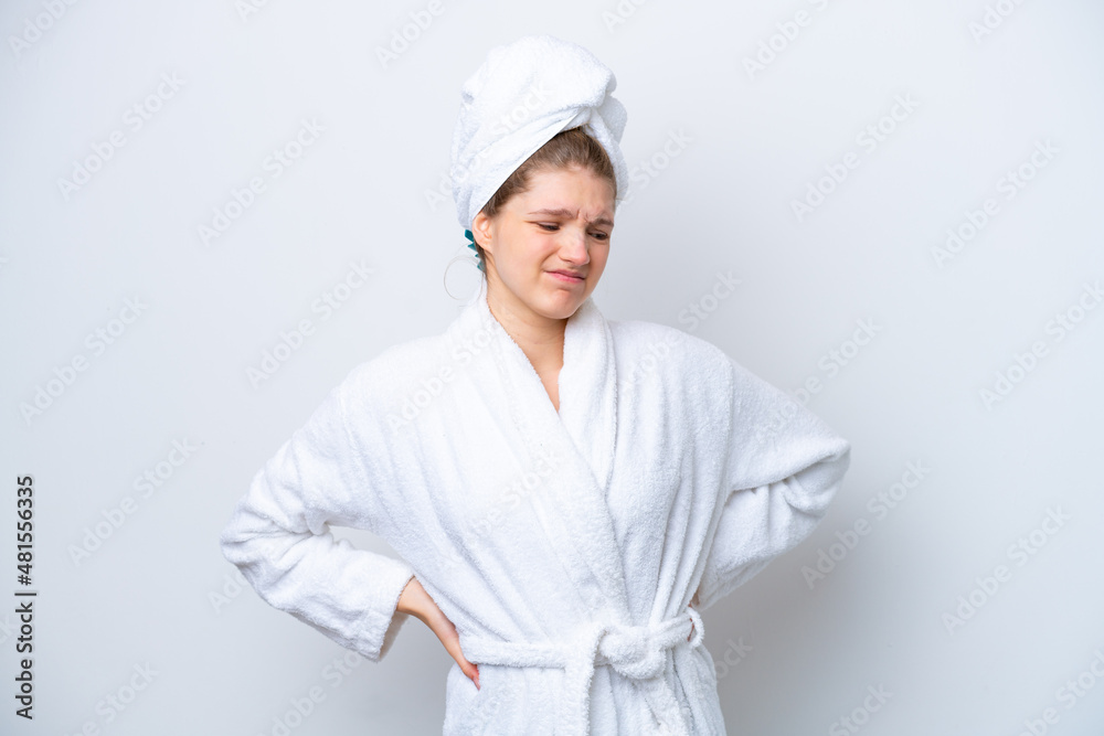 Teenager Russian girl in a bathrobe isolated on white background suffering from backache for having made an effort Teenager Russian girl in a bathrobe isolated on white background suffering from backache for having made an effort