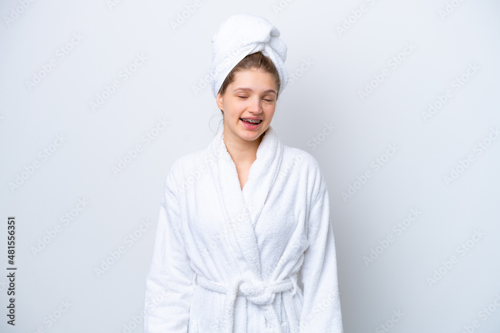 Teenager Russian girl in a bathrobe isolated on white background laughing Teenager Russian girl in a bathrobe isolated on white background laughing