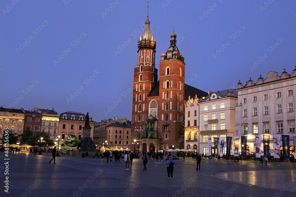 Krakow old night illuminated square and Mariacka cathedral, Stare Miasto, Rynek Glowny, Poland
