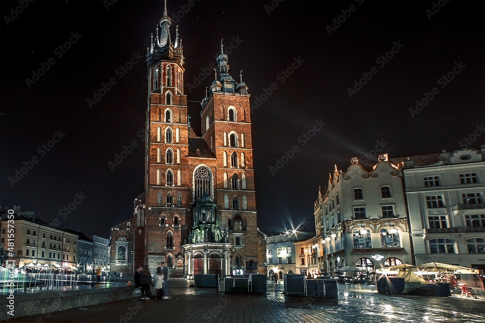 Krakow old night illuminated square and Mariacka cathedral, Rynek Glowny, Stare Miasto, Poland