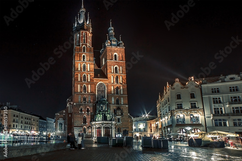Krakow old night illuminated square and Mariacka cathedral, Rynek Glowny, Stare Miasto, Poland