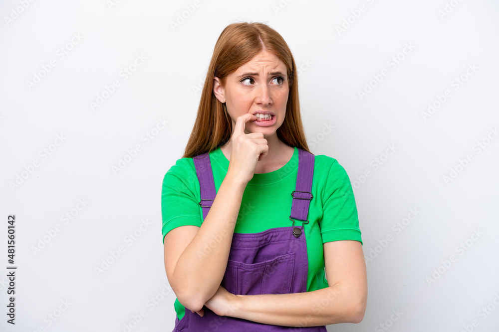 Young redhead woman isolated on white background nervous and scared