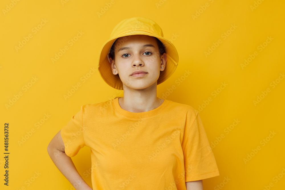beautiful girl in a yellow t-shirt and Hat emotions summer style isolated background beautiful girl in a yellow t-shirt and Hat emotions summer style isolated background