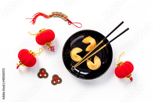 Asian style tabble place setting with fortune cookies and golden chopsticks
