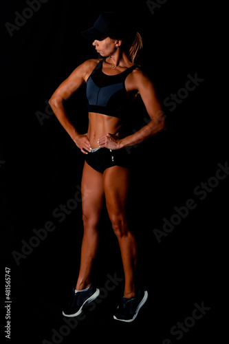 Fitness female woman with muscular body, do her workout. Attractive sexy fitness woman, trained female body, lifestyle portrait, caucasian model.