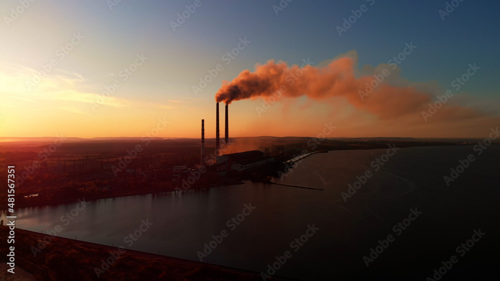 Aerial Drone View: High Chimney Pipes with dirt smoke from Coal Power Plant. Production of Electricity with Fossil Fuel.