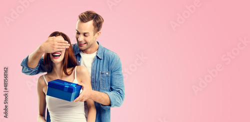 Slika na platnu Holiday sales actions, rebates, discounts offers concept image - happy amorous couple with blue gift box