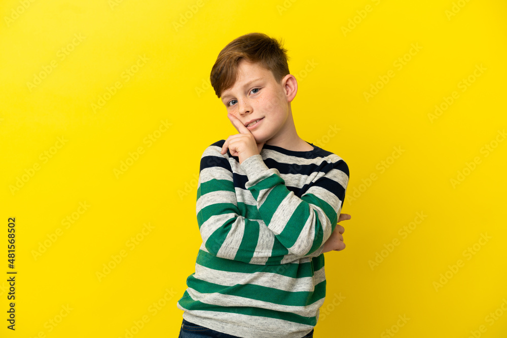 Little redhead boy isolated on yellow background happy and smiling Little redhead boy isolated on yellow background happy and smiling