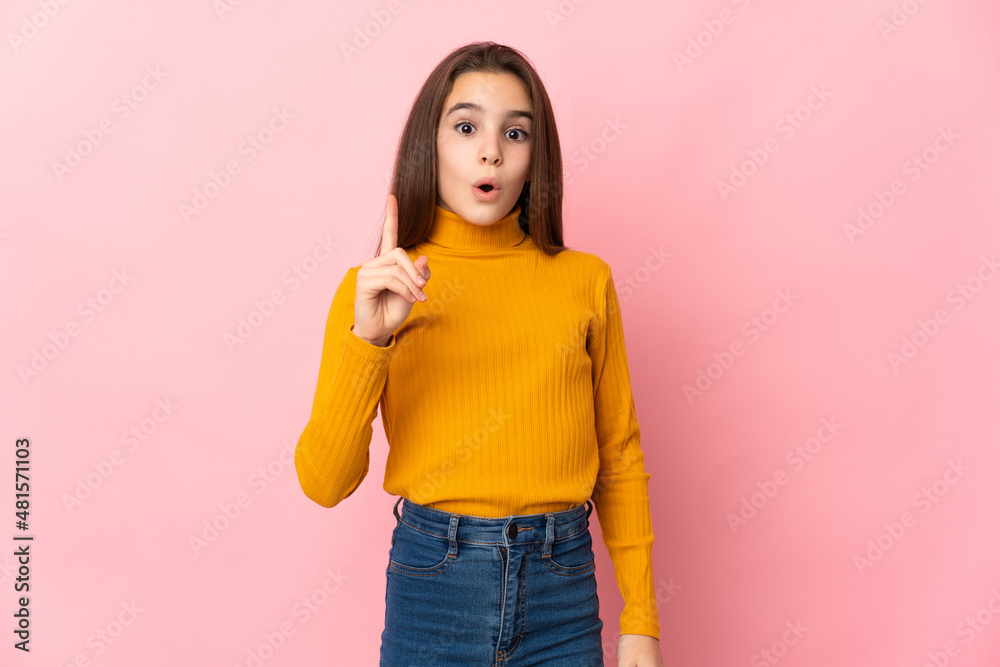 Little girl isolated on pink background intending to realizes the solution while lifting a finger up Little girl isolated on pink background intending to realizes the solution while lifting a finger up