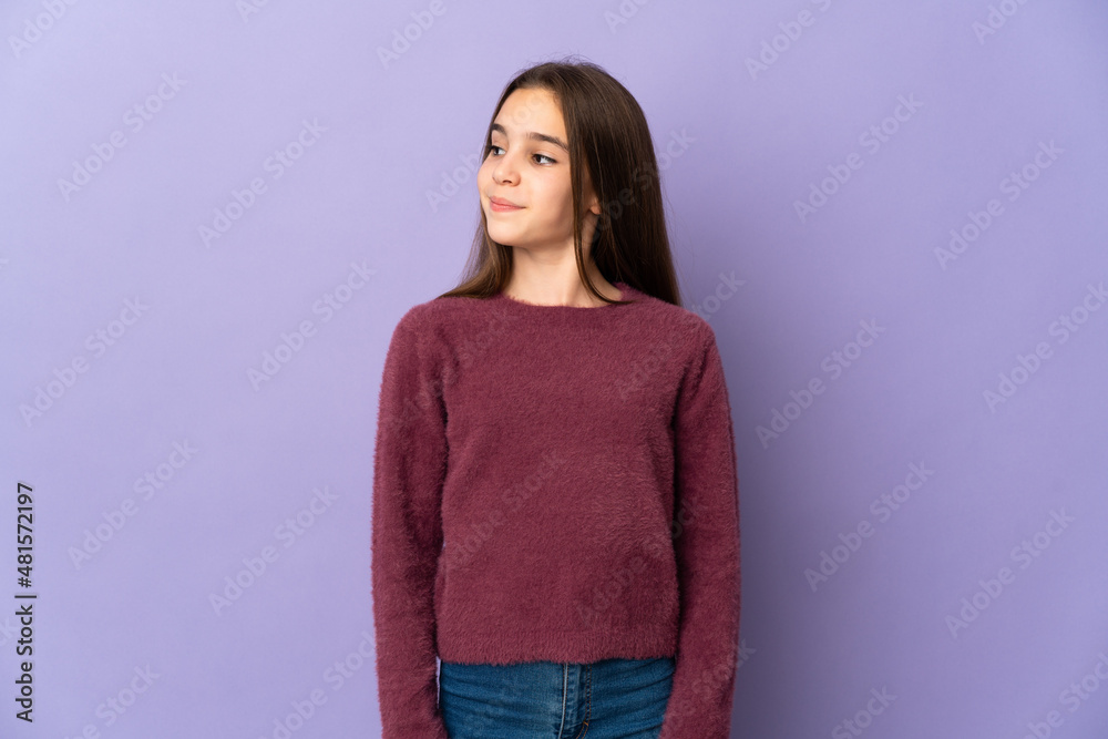Little girl isolated on purple background having doubts while looking side Little girl isolated on purple background having doubts while looking side