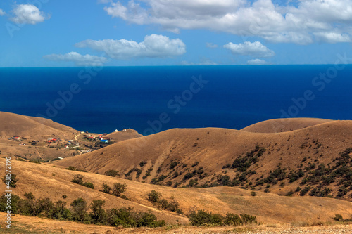 Seascape from the top of the mountains. The nature of the sea. Clouds  sea  mountains. A sunny day. Horizontal photo. Vacation  travel. Concept  calendar  cover.