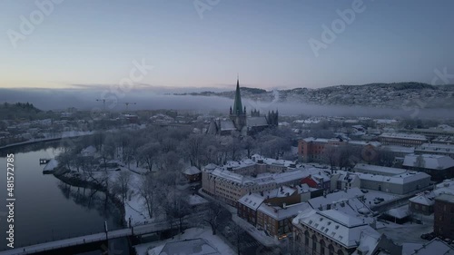Flying Towards The Nidaros Cathedral With Winter Landscape In Trondheim City, Trondelag, Norway. - aerial approach photo