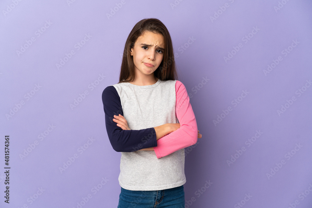 Little girl isolated on purple background feeling upset