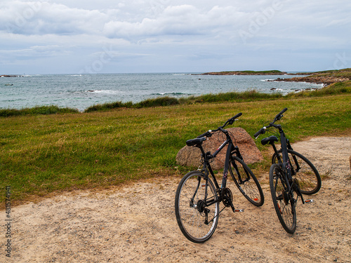 two bicycles on the sand near the coast in Brittany, France