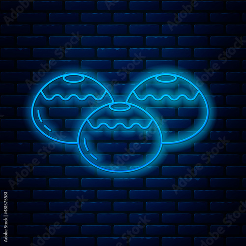Glowing neon line Jewish sweet bakery icon isolated on brick wall background. Hanukkah sufganiyot. Jewish easter cake. Vector