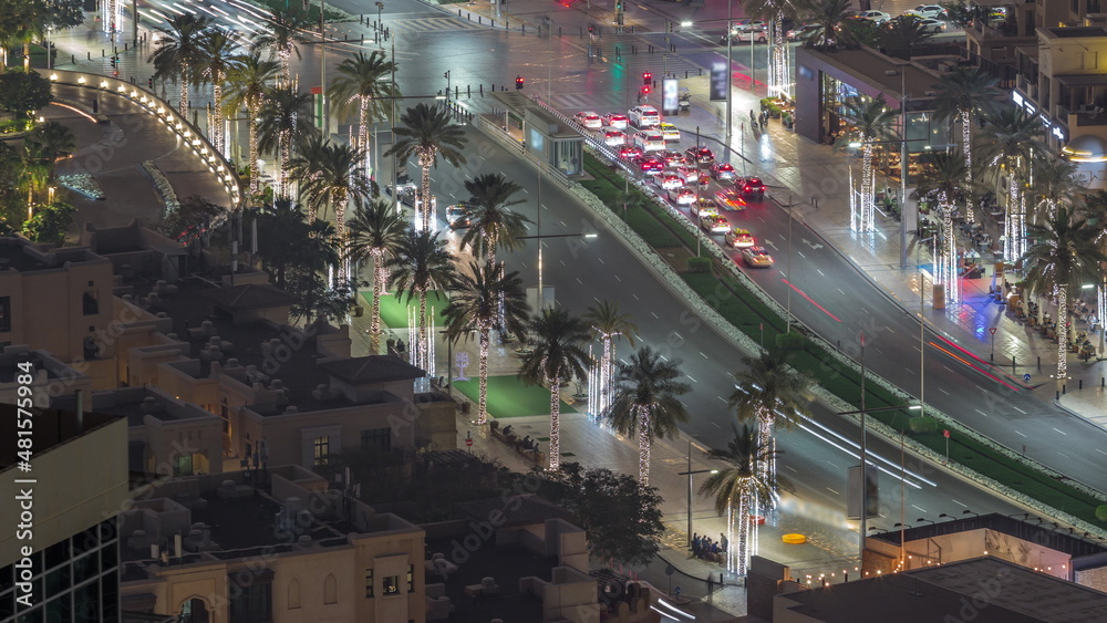 Bussy traffic on the road intersection in Dubai downtown aerial night timelapse, UAE