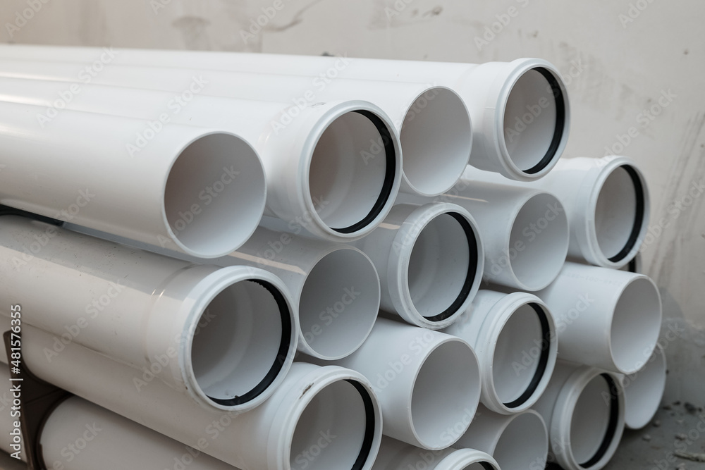 Fototapeta premium White pipes with rubber sealing rings. PVC tube pipe,Plastic pipe or polypropylene or polyethylene, stacked white round profile.Durable and anticorrosive properties of water pipes, drainage system