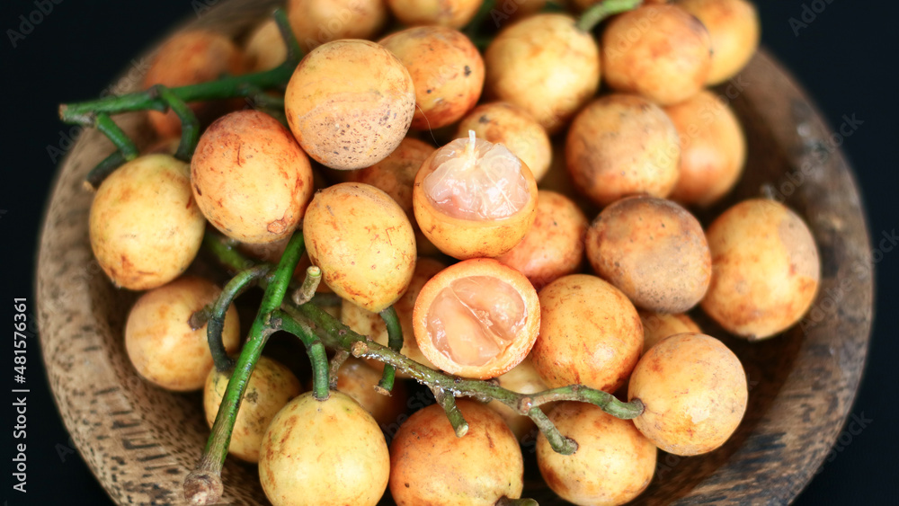 Menteng fruit or Baccaurea racemosa on wood plate. Menteng fruit or Baccaurea racemosa on wood plate.