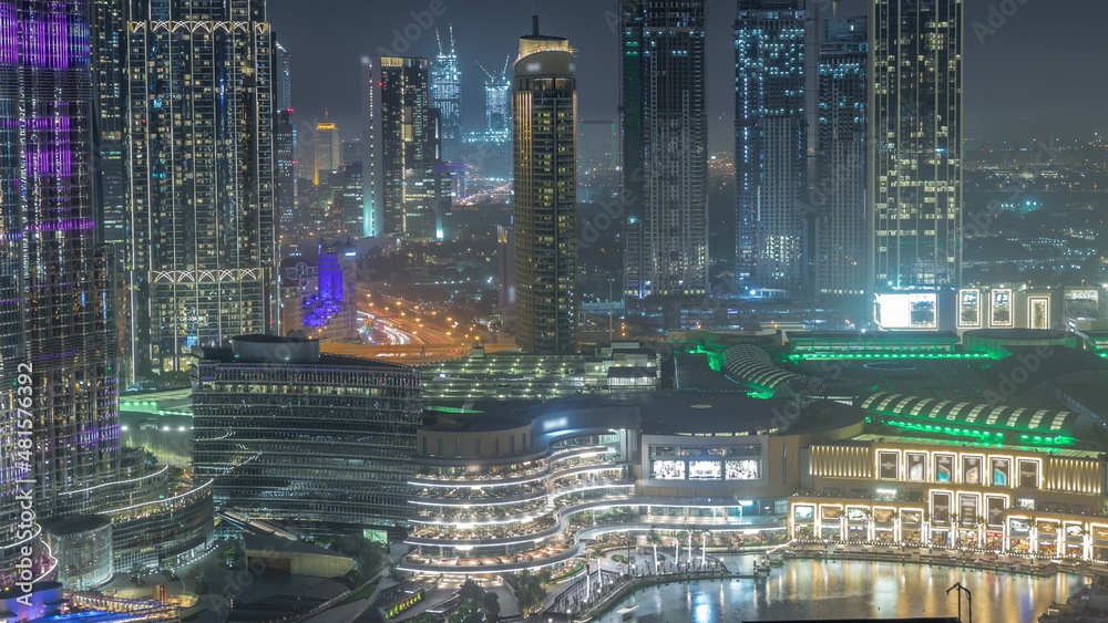 Dubai downtown near fountains and modern futuristic architecture aerial night timelapse