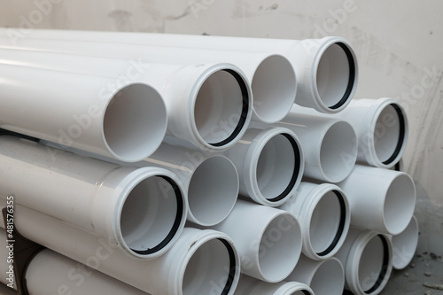 White pipes with rubber sealing rings. PVC tube pipe,Plastic pipe or polypropylene or polyethylene, stacked white round profile.Durable and anticorrosive properties of water pipes, drainage system