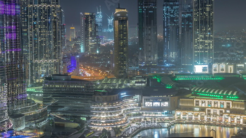 Dubai downtown near fountains and modern futuristic architecture aerial night timelapse