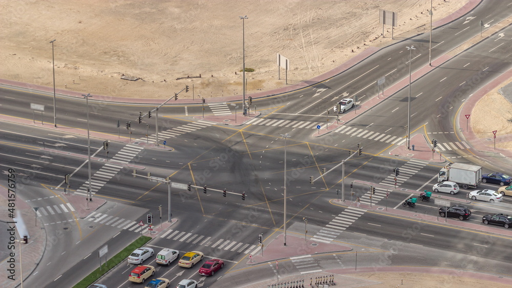 Bussy traffic on the road intersection in Dubai downtown aerial timelapse, UAE