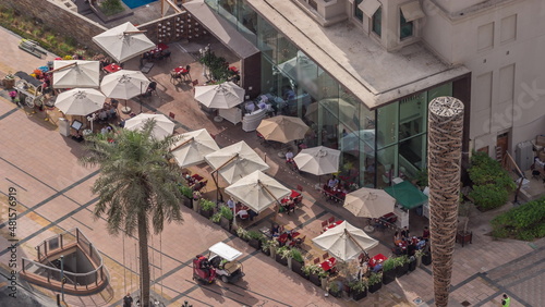 Photography Outdoor terrace with tables and chairs under umbrellas in restaurant aerial top
