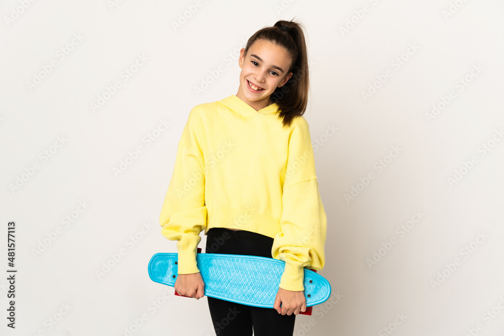 Little girl isolated on white background with a skate with happy expression Little girl isolated on white background with a skate with happy expression