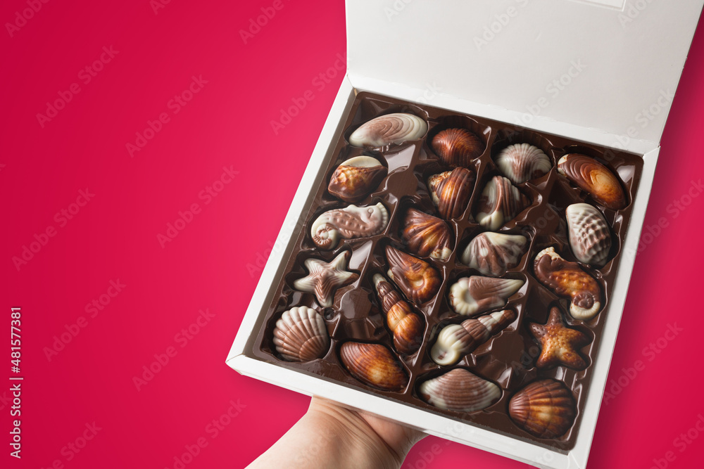 Box of chocolates on red background.