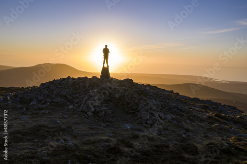 Silhouette of a person in the mountains at sunset in Snowdonia North Wales