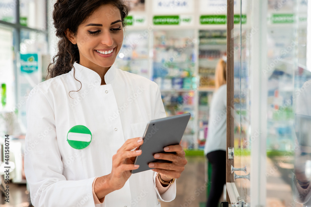 Portrait of female pharmacist working in drugstore.