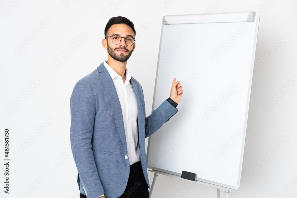 Young caucasian man isolated on white background giving a presentation on white board Young caucasian man isolated on white background giving a presentation on white board