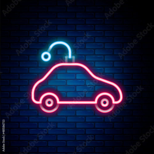 Glowing neon line Radio controlled car toy icon isolated on brick wall background. Control remote car toy. Colorful outline concept. Vector