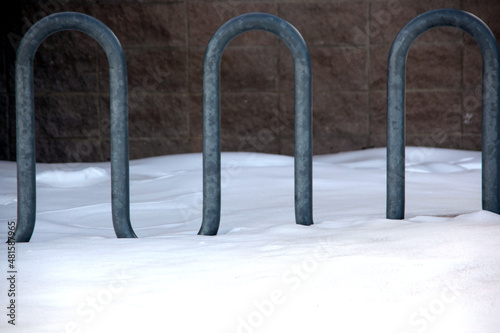 Snow covered fence outdoors.